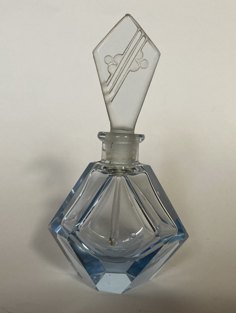 Blue perfume with floral stopper